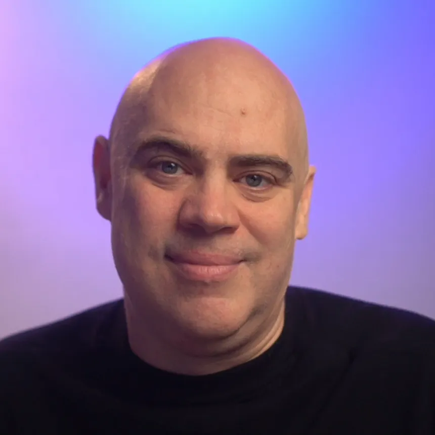 Fabian Krumbholz, smiling, against a blue and purple backdrop